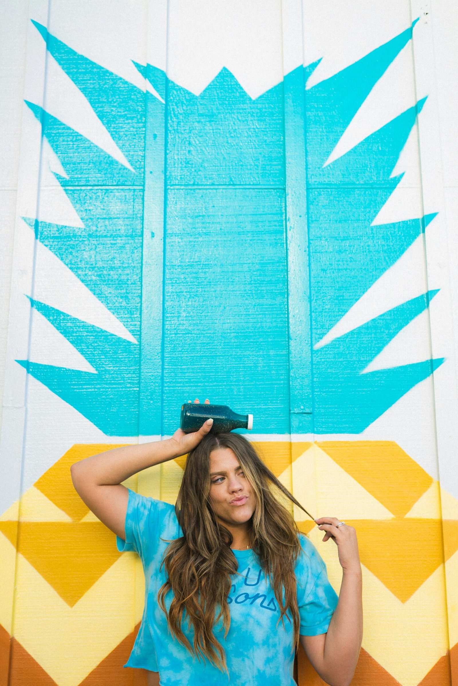 woman in blue t-shirt wearing black fedora hat